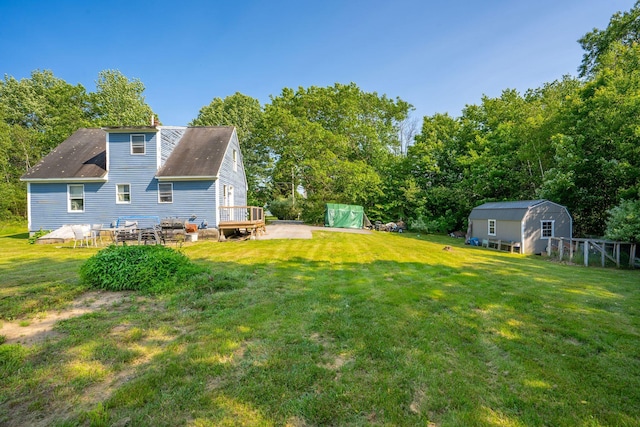 104 Chick Rd, Lebanon, ME 04027 - view of grassy yard with a storage shed, a patio, and view of wooded area