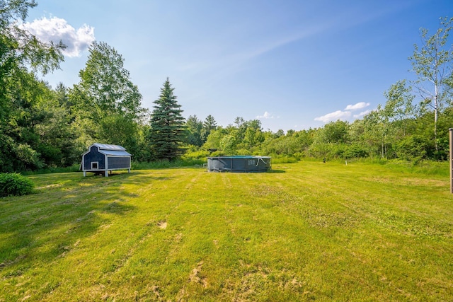 104 Chick Rd, Lebanon, ME 04027 - view of green lawn featuring an outdoor pool and an outbuilding