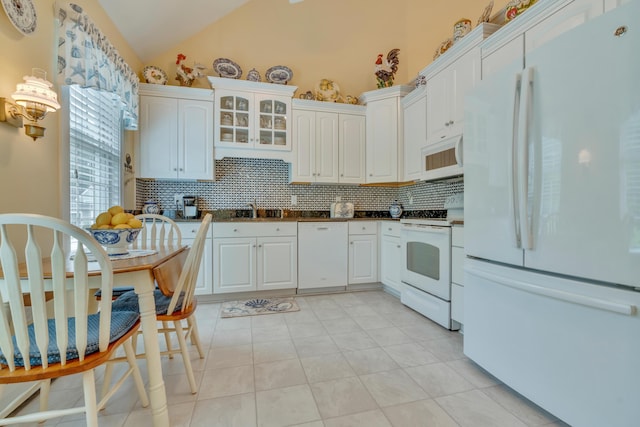 86 Farragut Way Unit 86, Kennebunk, ME 04043 - kitchen featuring white appliances, decorative backsplash, dark countertops, white cabinets, and vaulted ceiling