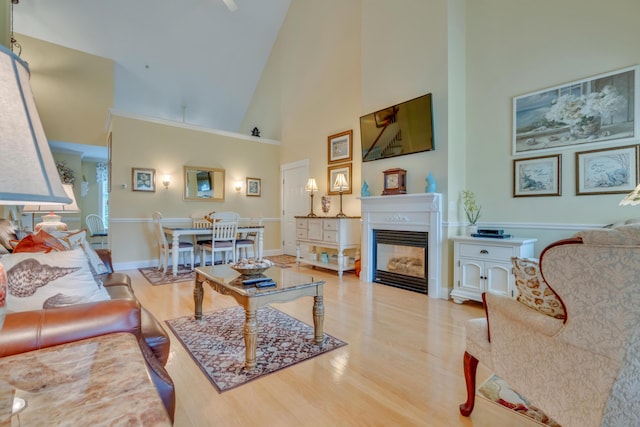 86 Farragut Way Unit 86, Kennebunk, ME 04043 - living room featuring high vaulted ceiling, wood finished floors, and a glass covered fireplace
