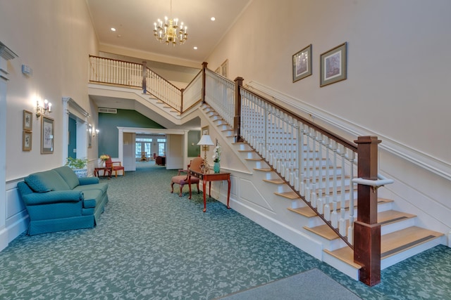 86 Farragut Way Unit 86, Kennebunk, ME 04043 - stairs with a decorative wall, carpet floors, a towering ceiling, a chandelier, and a wainscoted wall