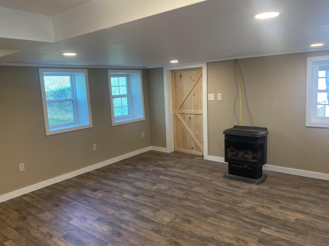 23 Page Rd, Enfield, ME 04493 - below grade area featuring a wood stove, recessed lighting, and dark wood finished floors