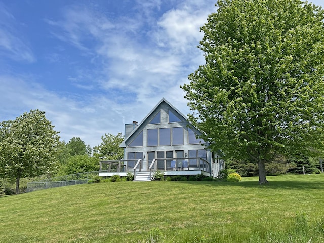 31 Deer Run, Lamoine, ME 04605 - rear view of house with a chimney and a wooden deck