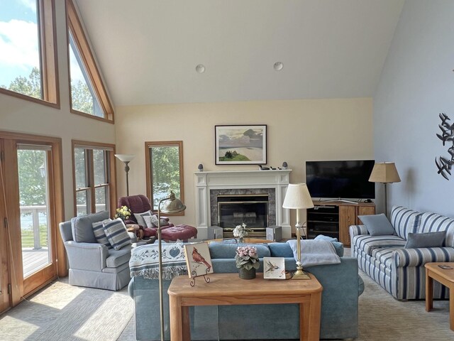 31 Deer Run, Lamoine, ME 04605 - carpeted living room with plenty of natural light, high vaulted ceiling, and a high end fireplace