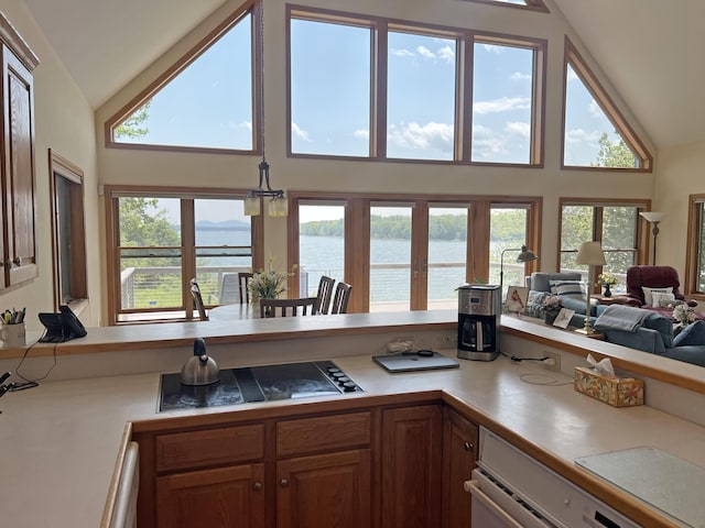 31 Deer Run, Lamoine, ME 04605 - kitchen featuring high vaulted ceiling, black electric cooktop, a water view, light countertops, and open floor plan