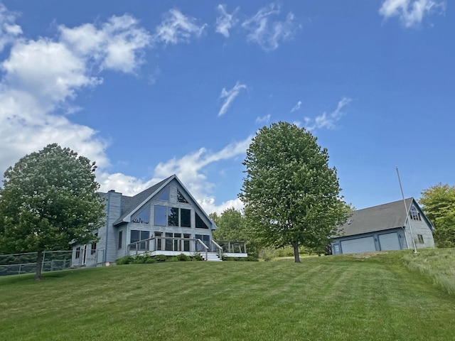 31 Deer Run, Lamoine, ME 04605 - rear view of house featuring a detached garage and a chimney