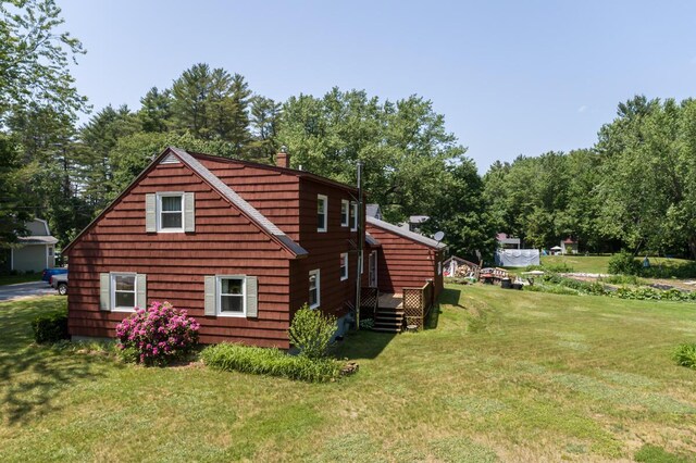 69 Garfield Rd, Auburn, ME 04210 - view of property exterior with a lawn and a chimney