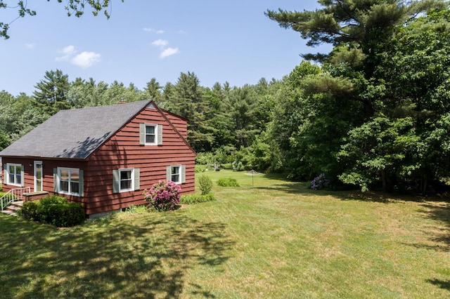 69 Garfield Rd, Auburn, ME 04210 - view of side of home featuring a lawn and a view of trees