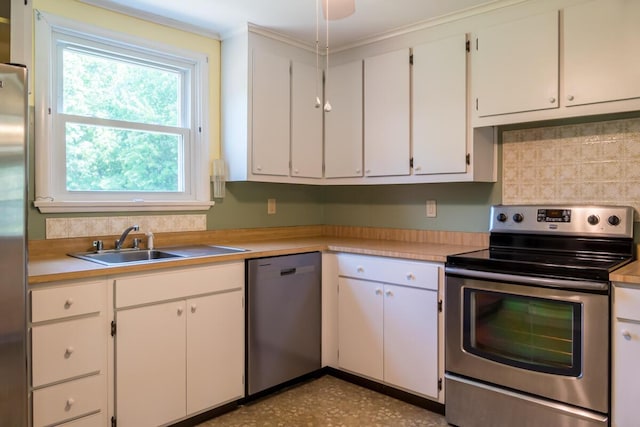 69 Garfield Rd, Auburn, ME 04210 - kitchen with stainless steel appliances, light countertops, tasteful backsplash, and white cabinets