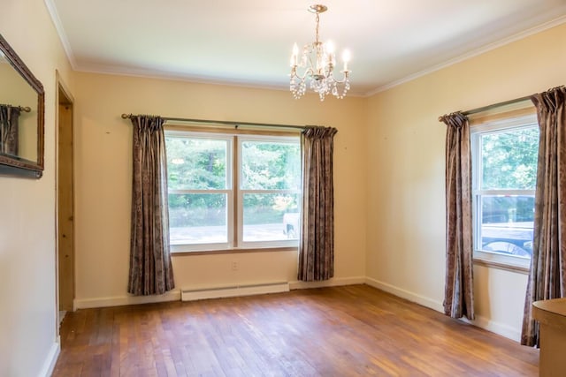 69 Garfield Rd, Auburn, ME 04210 - unfurnished room featuring a baseboard heating unit, a chandelier, wood finished floors, plenty of natural light, and ornamental molding