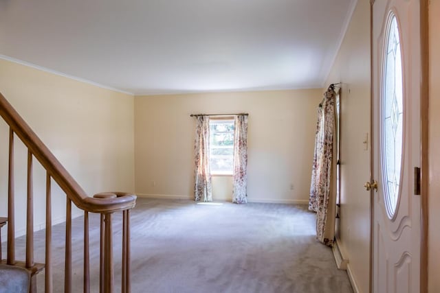 69 Garfield Rd, Auburn, ME 04210 - entryway with light colored carpet, crown molding, and stairs