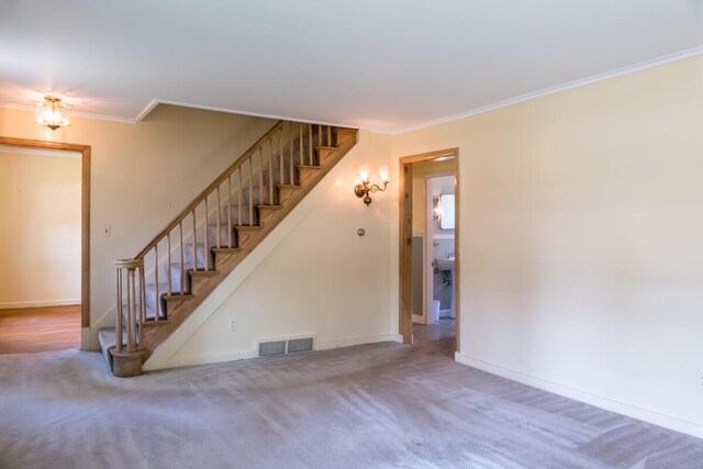 69 Garfield Rd, Auburn, ME 04210 - unfurnished living room with stairs, ornamental molding, and carpet floors