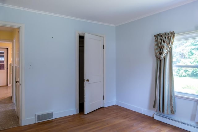 69 Garfield Rd, Auburn, ME 04210 - unfurnished room with a baseboard radiator, wood finished floors, and crown molding