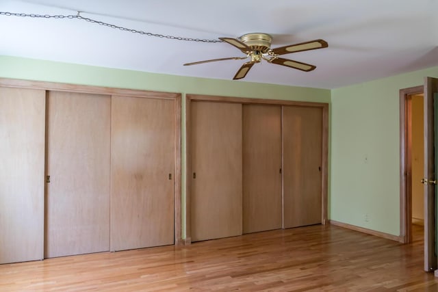 69 Garfield Rd, Auburn, ME 04210 - unfurnished bedroom with multiple closets, wood finished floors, and ceiling fan