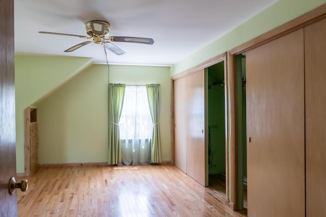 69 Garfield Rd, Auburn, ME 04210 - unfurnished bedroom with two closets, light wood finished floors, and ceiling fan