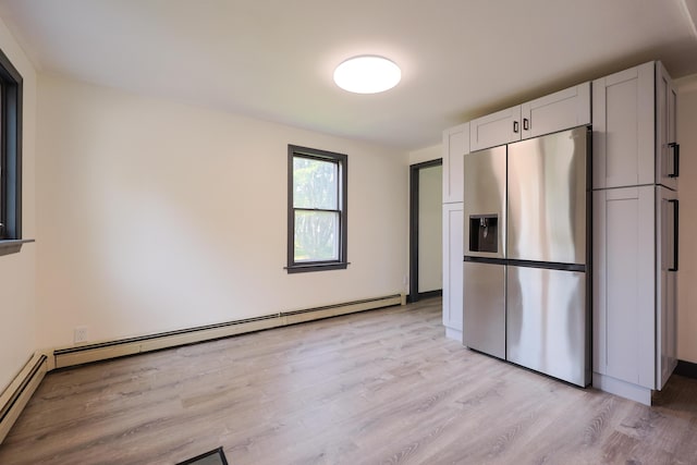 9 Jean St, Kittery, ME 03904 - kitchen featuring stainless steel fridge, a baseboard radiator, light wood-style floors, and white cabinets