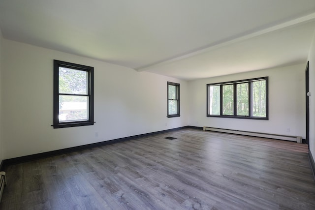 9 Jean St, Kittery, ME 03904 - empty room featuring a baseboard heating unit, healthy amount of natural light, and wood finished floors