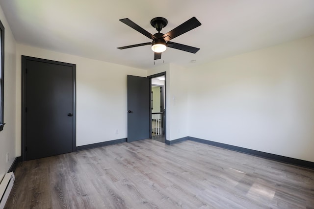 9 Jean St, Kittery, ME 03904 - unfurnished bedroom with wood finished floors, a baseboard radiator, and a ceiling fan