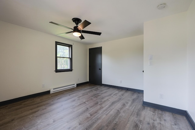 9 Jean St, Kittery, ME 03904 - spare room with a baseboard heating unit, wood finished floors, ceiling fan, and a smoke detector