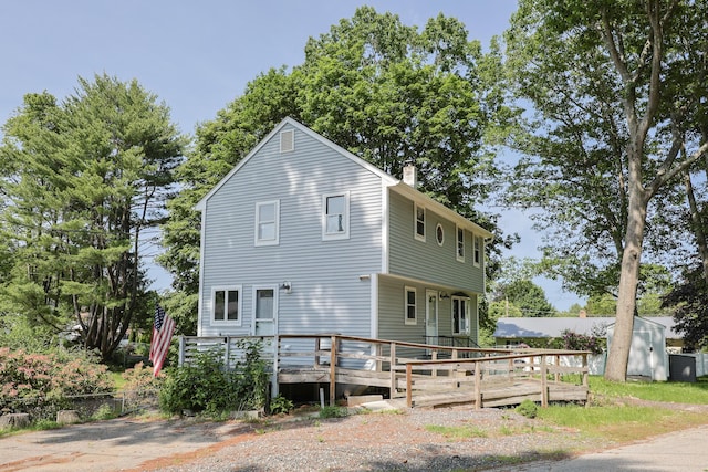 9 Jean St, Kittery, ME 03904 - view of side of home with a chimney and a deck
