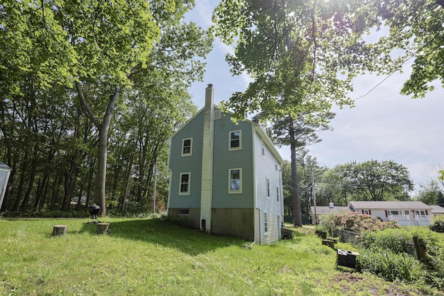 9 Jean St, Kittery, ME 03904 - view of home's exterior with a chimney and a lawn