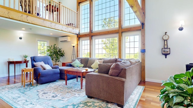 111 Quaker Hill Rd, Unity, ME 04988 - living area with an AC wall unit, wood-type flooring, and a towering ceiling