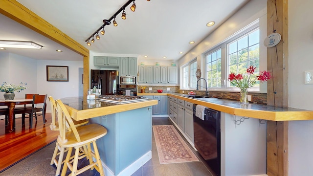 111 Quaker Hill Rd, Unity, ME 04988 - kitchen featuring black appliances, a kitchen bar, tasteful backsplash, recessed lighting, and butcher block countertops