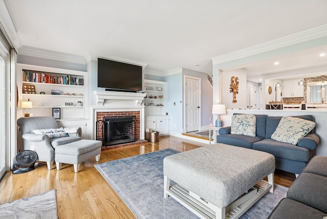 135 Ocean Ave Unit 15, Kennebunkport, ME 04046 - living area featuring wood finished floors, crown molding, and a brick fireplace