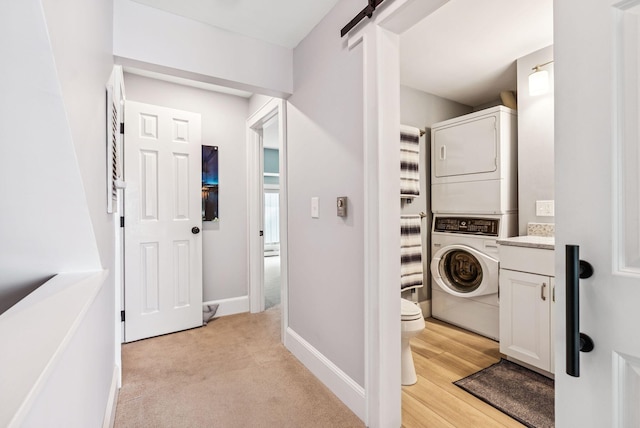 135 Ocean Ave Unit 15, Kennebunkport, ME 04046 - washroom featuring estacked washer and dryer and light colored carpet