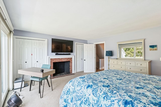 135 Ocean Ave Unit 15, Kennebunkport, ME 04046 - carpeted bedroom featuring multiple closets and a brick fireplace