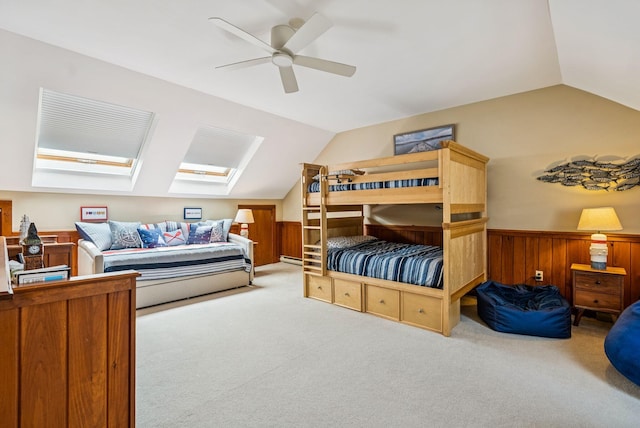 135 Ocean Ave Unit 15, Kennebunkport, ME 04046 - carpeted bedroom with lofted ceiling, a wainscoted wall, ceiling fan, wooden walls, and a skylight
