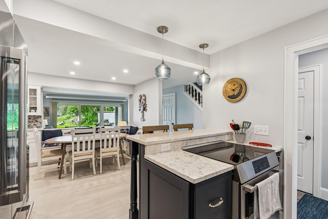 135 Ocean Ave Unit 15, Kennebunkport, ME 04046 - kitchen featuring stainless steel appliances, light wood-style floors, recessed lighting, light stone countertops, and decorative light fixtures