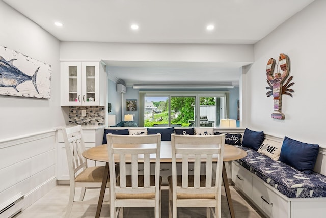135 Ocean Ave Unit 15, Kennebunkport, ME 04046 - dining space featuring baseboard heating, breakfast area, recessed lighting, wainscoting, and a wall mounted air conditioner