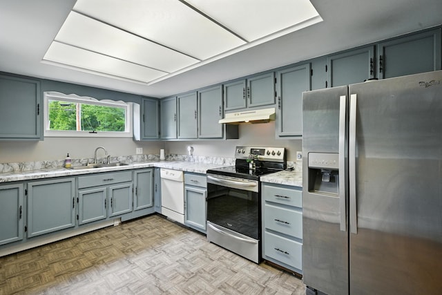 22 Sanborn Cir, Norway, ME 04268 - kitchen with stainless steel appliances, under cabinet range hood, light countertops, and gray cabinets