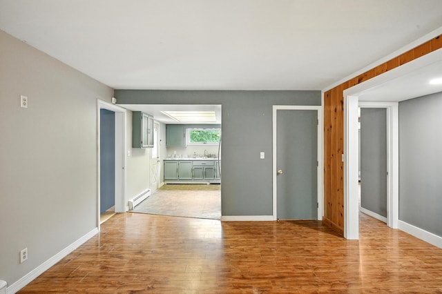 22 Sanborn Cir, Norway, ME 04268 - unfurnished living room with baseboard heating and light wood-style floors