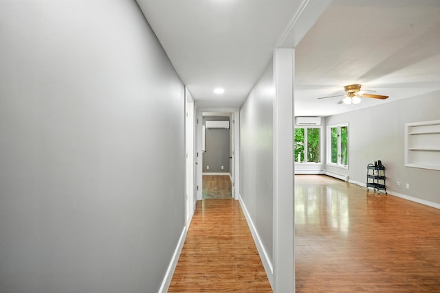22 Sanborn Cir, Norway, ME 04268 - hallway featuring a wall mounted AC, wood finished floors, a wall mounted air conditioner, and built in features