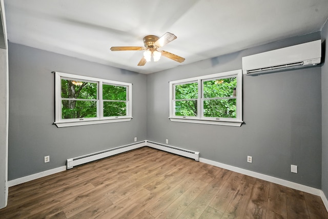 22 Sanborn Cir, Norway, ME 04268 - empty room featuring a wall unit AC, a ceiling fan, wood finished floors, and baseboard heating