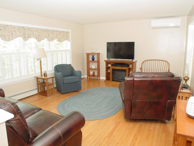 976 Essex St, Bangor, ME 04401 - living room with a baseboard heating unit, wood finished floors, a wall mounted AC, and a glass covered fireplace