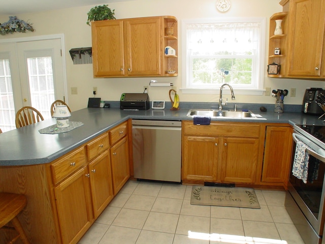 976 Essex St, Bangor, ME 04401 - kitchen with stainless steel appliances, open shelves, a peninsula, light tile patterned floors, and dark countertops