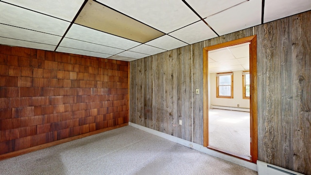 84 Elm St, Sabattus, ME 04280 - spare room with baseboard heating, a baseboard radiator, wooden walls, and a drop ceiling