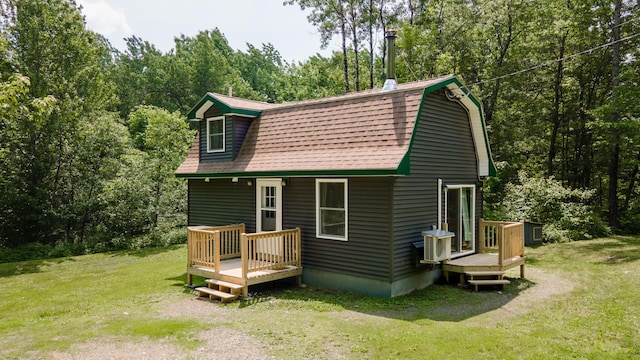 711 Stetson Rd, Exeter, ME 04435 - rear view of property featuring a yard, a gambrel roof, and a wooden deck