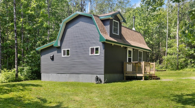 711 Stetson Rd, Exeter, ME 04435 - view of side of home featuring a yard, a gambrel roof, a deck, and a view of trees