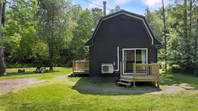 711 Stetson Rd, Exeter, ME 04435 - rear view of house with a deck, a lawn, and a gambrel roof