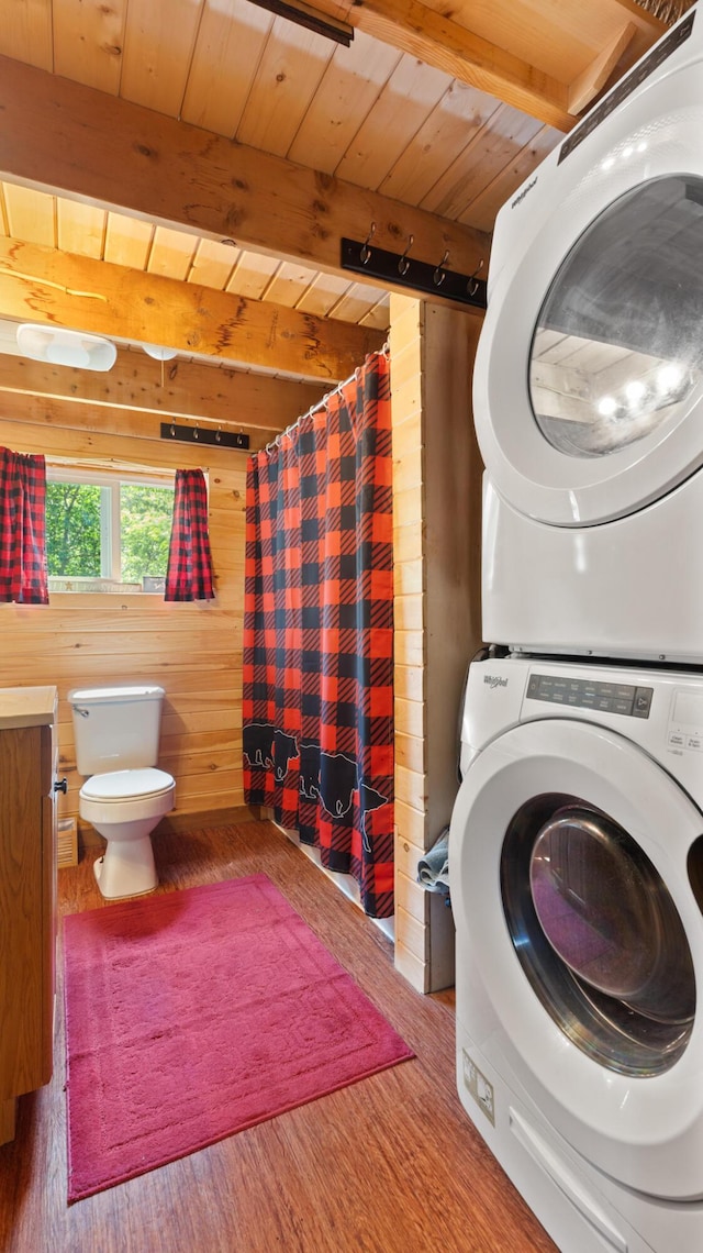 711 Stetson Rd, Exeter, ME 04435 - laundry area featuring stacked washer / drying machine, wooden ceiling, wood finished floors, and wood walls