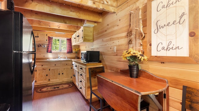 711 Stetson Rd, Exeter, ME 04435 - kitchen with freestanding refrigerator, dark wood-style flooring, light countertops, and beamed ceiling