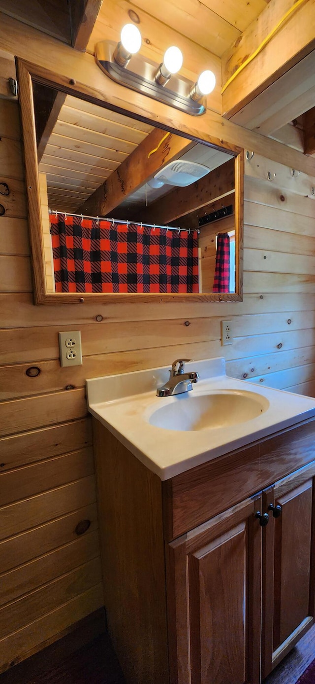711 Stetson Rd, Exeter, ME 04435 - full bath featuring a wood ceiling with exposed beams, wood walls, and vanity
