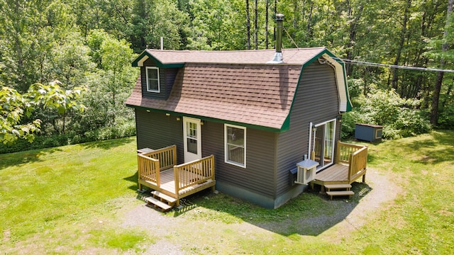 711 Stetson Rd, Exeter, ME 04435 - back of house with a lawn, a gambrel roof, a deck, and a shingled roof