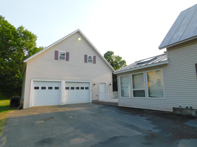 27 Main St, Norridgewock, ME 04957 - view of side of home featuring a standing seam roof, a metal roof, and a detached garage