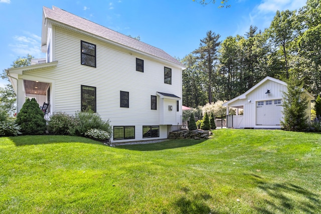 56 Ledgewood Dr, Falmouth, ME 04105 - back of house featuring a detached garage, a yard, an outdoor structure, and roof with shingles