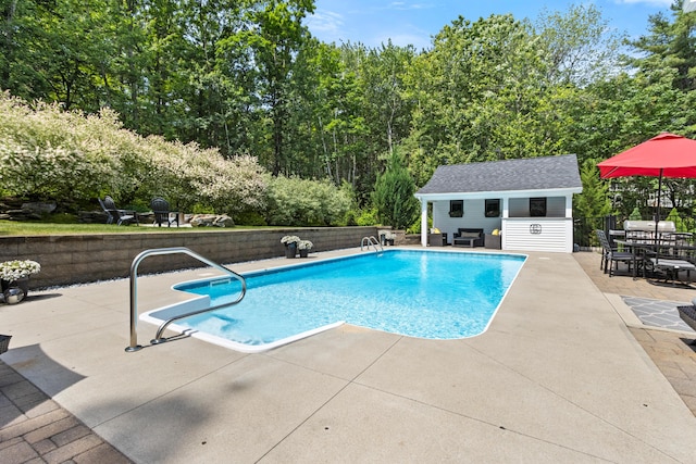 56 Ledgewood Dr, Falmouth, ME 04105 - view of pool with an exterior structure, a patio, and an outbuilding